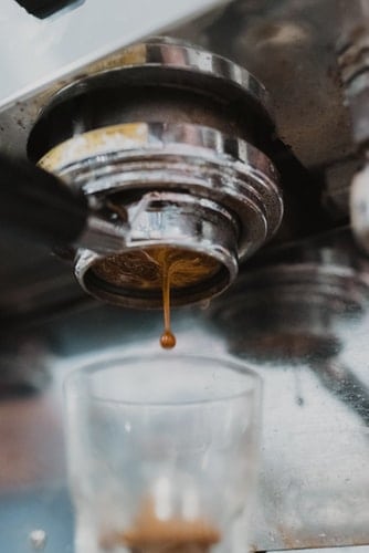Espresso pouring out of a portafilter 