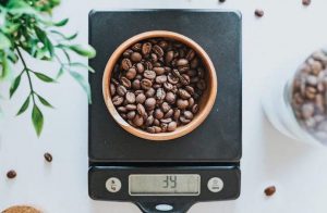 a container with coffee beans on a coffee scale