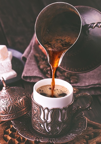 Turkish coffee into traditional embossed metal cup